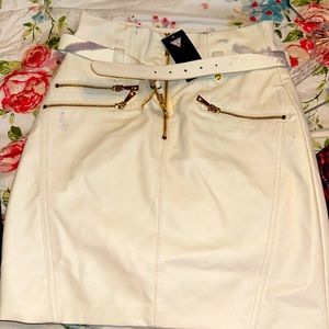 Guess size 4 skirt white leather never worn has stains on sides of skirt. NWT